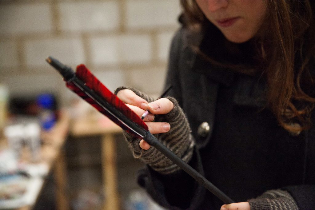 Painting the white bits of fletching black. 