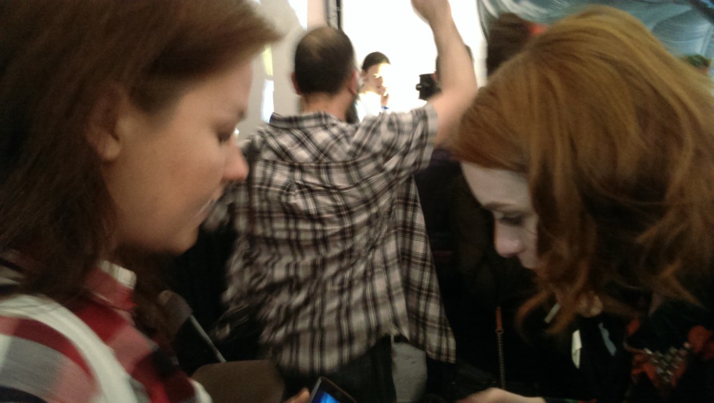 A blurry image of Kate showing Felicia some Ren clips.